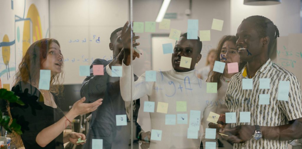 group of people in an office working with post-it-notes